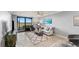 Open concept living space with modern furniture and sliding doors leading to a balcony at 5548 Palmer Cir # 102, Bradenton, FL 34211