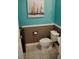 Small bathroom with teal and brown color scheme at 5662 Duval St, Bradenton, FL 34203