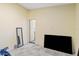 Bedroom with a large flat-screen TV and mirror at 612 5Th Avenue E Dr, Bradenton, FL 34208