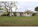 Large backyard with a grassy area and mature trees at 6203 Marina Dr, Holmes Beach, FL 34217