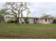 Large backyard with a grassy area and mature trees at 6203 Marina Dr, Holmes Beach, FL 34217