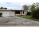 Ranch-style home with a single-car garage and a spacious yard at 6203 Marina Dr, Holmes Beach, FL 34217