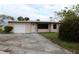 Light pink single story home with a large yard at 6203 Marina Dr, Holmes Beach, FL 34217
