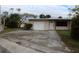Light pink single story home with a large yard at 6203 Marina Dr, Holmes Beach, FL 34217