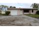 Ranch-style home with a single-car garage and a spacious yard at 6203 Marina Dr, Holmes Beach, FL 34217