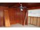 Room with wood paneling, ceiling fan and tiled floors at 6203 Marina Dr, Holmes Beach, FL 34217