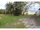 Spacious side yard with grassy area and mature trees at 6203 Marina Dr, Holmes Beach, FL 34217