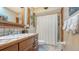 Charming bathroom with wood vanity, tile accents, and a shower/tub combo at 6246 Ravenwood Dr, Sarasota, FL 34243