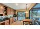 Kitchen with granite countertops, wood cabinets, and pool view at 6246 Ravenwood Dr, Sarasota, FL 34243