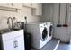 Laundry room has sink, cabinets, and washer and dryer at 6725 Roxbury Dr, Sarasota, FL 34231