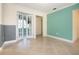 Bright living room featuring neutral tile floors, french doors and accent wall at 6725 Roxbury Dr, Sarasota, FL 34231