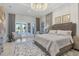 Luxurious bedroom with access to a private patio and lake view at 8540 Pavia Way, Lakewood Ranch, FL 34202