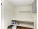 Clean, spacious basement storage area with shelving and workbench at 875 Royal Rd, Venice, FL 34293