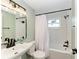 Modern bathroom with white subway tiles, white vanity, and bathtub at 875 Royal Rd, Venice, FL 34293