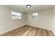 Spacious bedroom with wood-look floors and dual windows at 875 Royal Rd, Venice, FL 34293