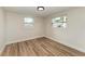 Bright bedroom with light walls and wood-look flooring at 875 Royal Rd, Venice, FL 34293