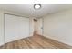 Spacious bedroom with light walls, wood-look flooring, and white closet doors at 875 Royal Rd, Venice, FL 34293