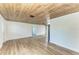 Entryway with white shiplap walls and a rustic wood ceiling at 875 Royal Rd, Venice, FL 34293