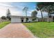 Newly renovated home with brick paver driveway and spacious lawn at 875 Royal Rd, Venice, FL 34293