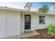 Modern black front door entrance with a welcome mat at 875 Royal Rd, Venice, FL 34293