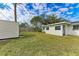 Back exterior of house with shed and yard at 875 Royal Rd, Venice, FL 34293