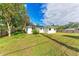 Back exterior view of the house and yard at 875 Royal Rd, Venice, FL 34293