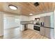 Modern kitchen with stainless steel appliances and wood ceiling at 875 Royal Rd, Venice, FL 34293