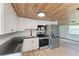 Modern kitchen with stainless steel appliances and wood ceiling at 875 Royal Rd, Venice, FL 34293