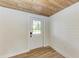 Laundry room with wood-look floors, shelving and new water heater at 875 Royal Rd, Venice, FL 34293