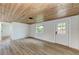Living room with wood-look floors and a white shiplap wall at 875 Royal Rd, Venice, FL 34293