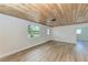 Open living area with wood-like floors and wood ceiling at 875 Royal Rd, Venice, FL 34293