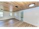 Living room featuring wood-look floors and access to exterior at 875 Royal Rd, Venice, FL 34293