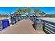 View from the pier showcasing beachgoers, palm trees, and the beachside restaurant at 875 Royal Rd, Venice, FL 34293