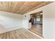 Sunroom features wood ceilings, built in bench, and kitchen views at 875 Royal Rd, Venice, FL 34293