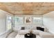 Relaxing sunroom with built-in seating and large windows at 875 Royal Rd, Venice, FL 34293