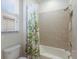 Simple bathroom with tub shower and bamboo shower curtain at 12232 Perennial Pl, Lakewood Ranch, FL 34211