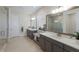 Elegant bathroom with double vanity, large mirror, and shower at 12232 Perennial Pl, Lakewood Ranch, FL 34211