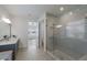 Modern bathroom with walk-in shower and gray tile at 12232 Perennial Pl, Lakewood Ranch, FL 34211