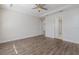 Spacious bedroom with wood-look floors and access to bathroom at 12232 Perennial Pl, Lakewood Ranch, FL 34211