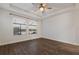 Bright bedroom featuring wood-look floors and lake views at 12232 Perennial Pl, Lakewood Ranch, FL 34211