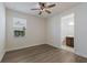 Bedroom with wood-look floors and adjacent bathroom at 12232 Perennial Pl, Lakewood Ranch, FL 34211