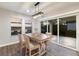 Dining room with sliding glass doors and pool view at 12232 Perennial Pl, Lakewood Ranch, FL 34211