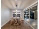 Dining room with sliding glass doors and pool view at 12232 Perennial Pl, Lakewood Ranch, FL 34211