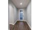 Light and airy entryway, featuring hardwood floors and a glass door at 12232 Perennial Pl, Lakewood Ranch, FL 34211