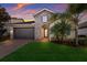 One-story home with stone accents and a two-car garage at sunset at 12232 Perennial Pl, Lakewood Ranch, FL 34211