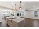 Open kitchen with island, granite countertops and pendant lighting at 12232 Perennial Pl, Lakewood Ranch, FL 34211