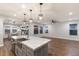 Modern kitchen with a large island, granite countertops, and stainless steel sink at 12232 Perennial Pl, Lakewood Ranch, FL 34211