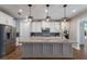 Modern kitchen features white cabinets, granite countertops, and stainless steel appliances at 12232 Perennial Pl, Lakewood Ranch, FL 34211