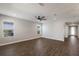 Bright living room featuring hardwood floors and ceiling fan at 12232 Perennial Pl, Lakewood Ranch, FL 34211