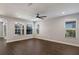 Bright living room featuring hardwood floors and ceiling fan at 12232 Perennial Pl, Lakewood Ranch, FL 34211